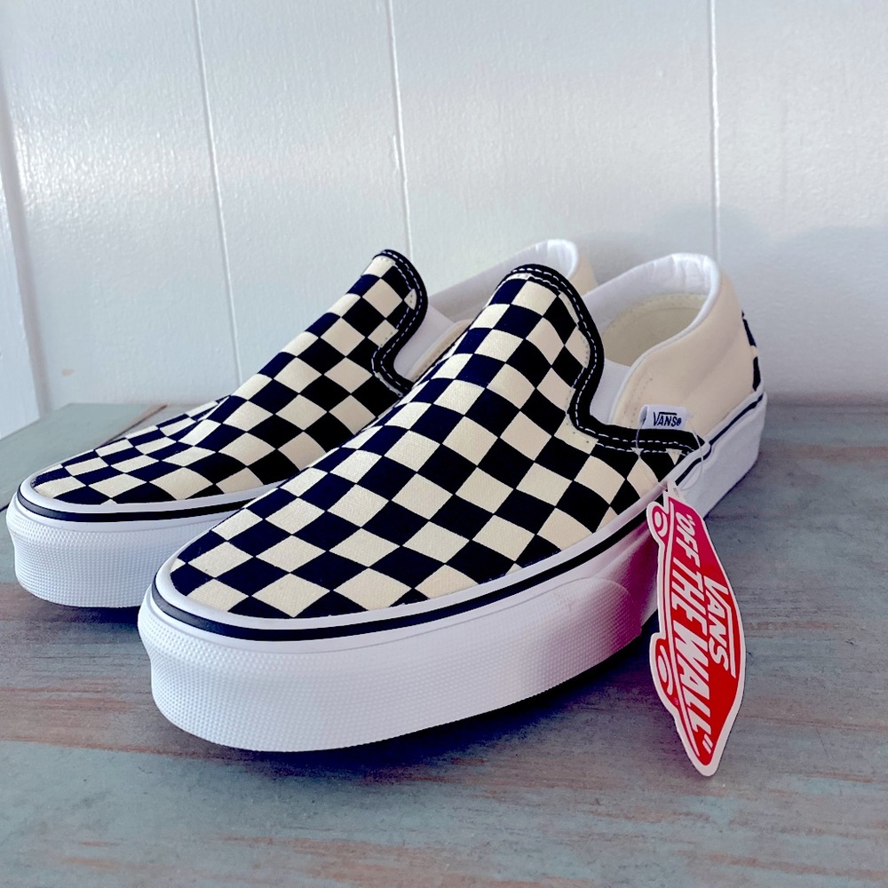 Checkered Vans slip-on shoes